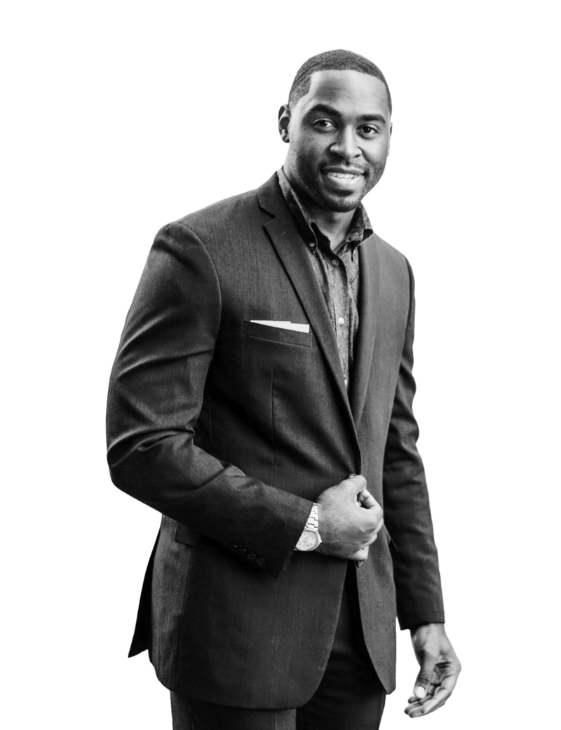 Marcus Nash smiling while wearing a suit in black and white