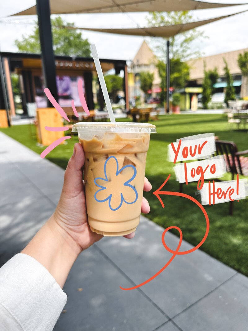 Iced Latte being held up with text your logo here and a blue hand drawn flower