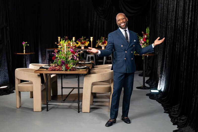 TyRon Wells, founder and creative director of Wells Design Co., standing beside a luxury floral tablescape in Memphis, Tennessee