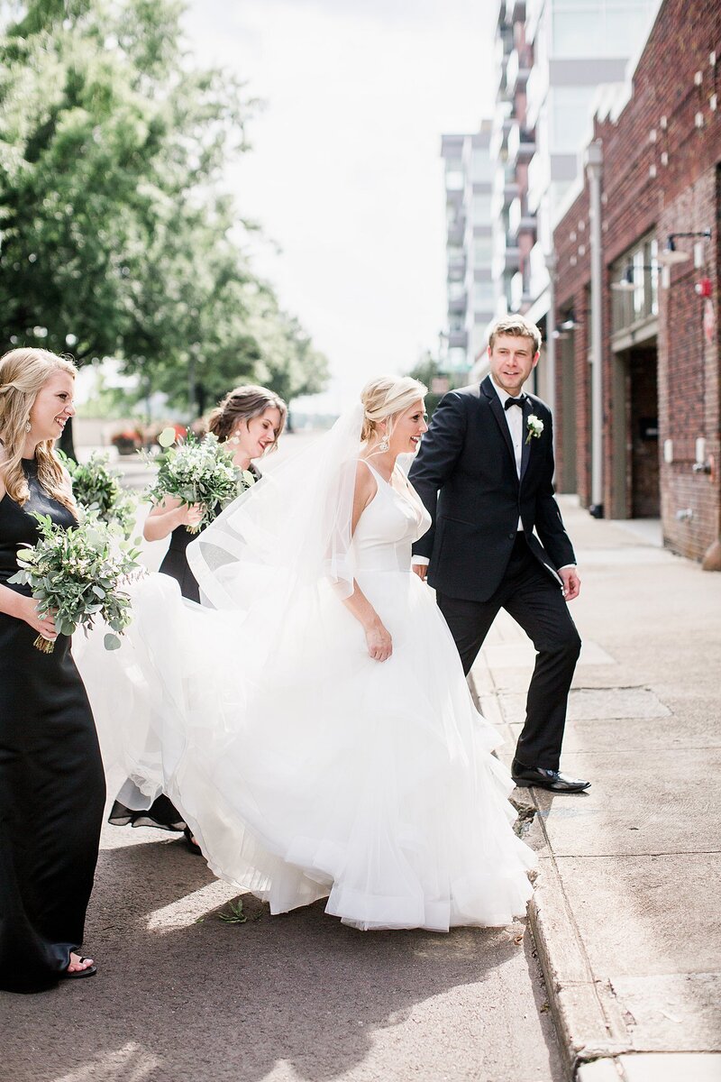 bridesmaid holding train by Knoxville Wedding Photographer, Amanda May Photos