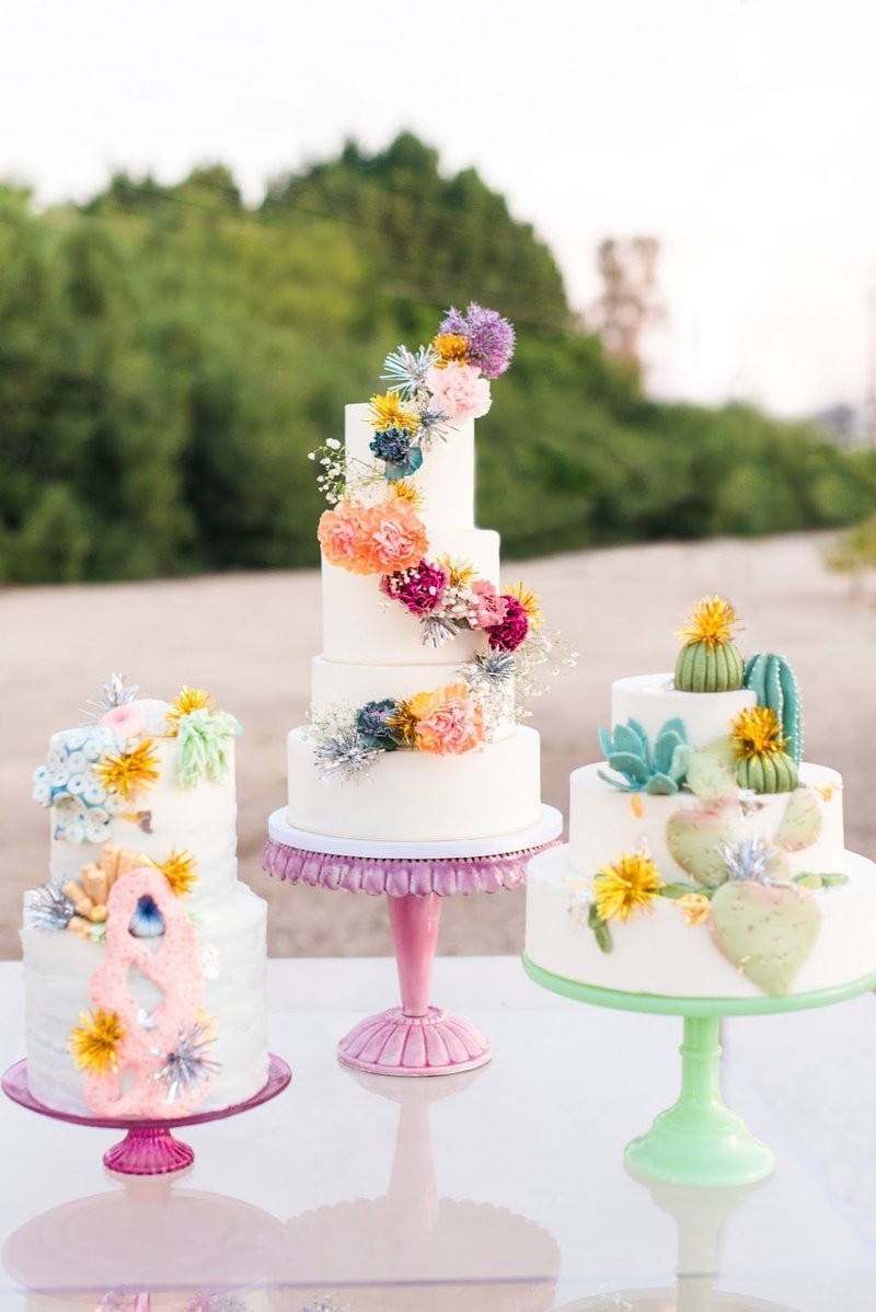 Three wedding cakes with rainbow florals