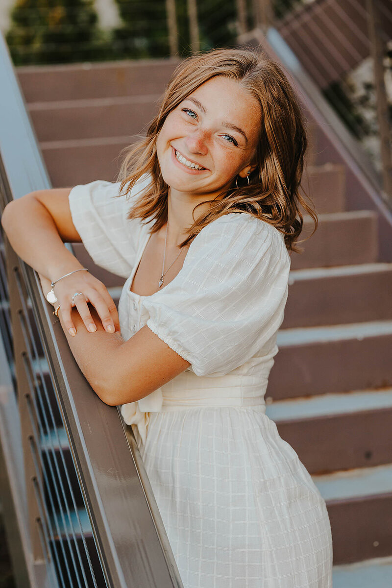 woman posing by stairs