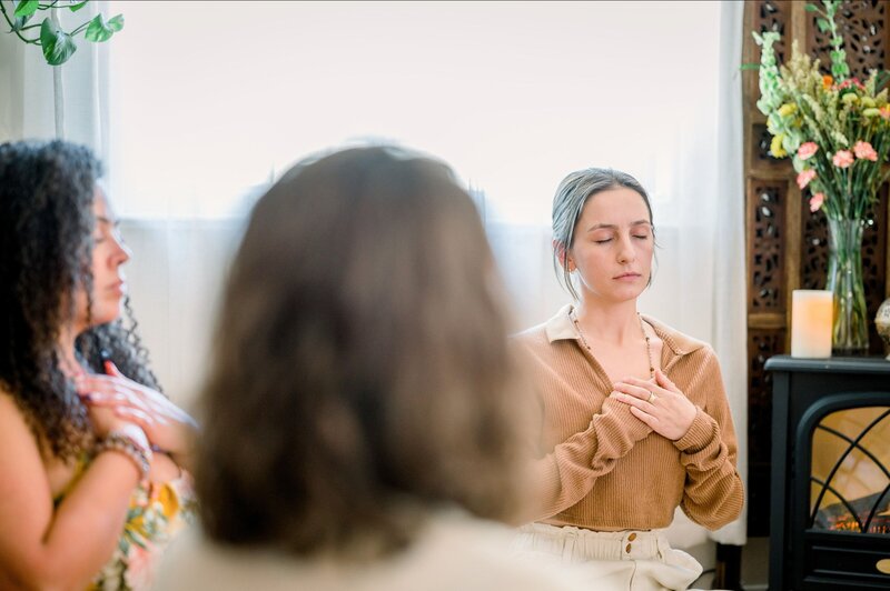 Participants meditating in a spiritual transformation class