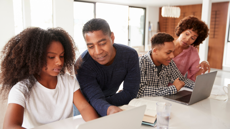 Family working together managing paperwork and daily tasks, representing ADHD-related executive function challenges and relational stress