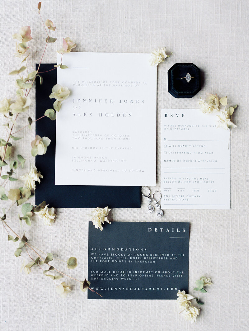 a wedding invitation suite with flowers and jewelry