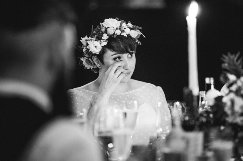 A bride wipes away a tear during the speeches
