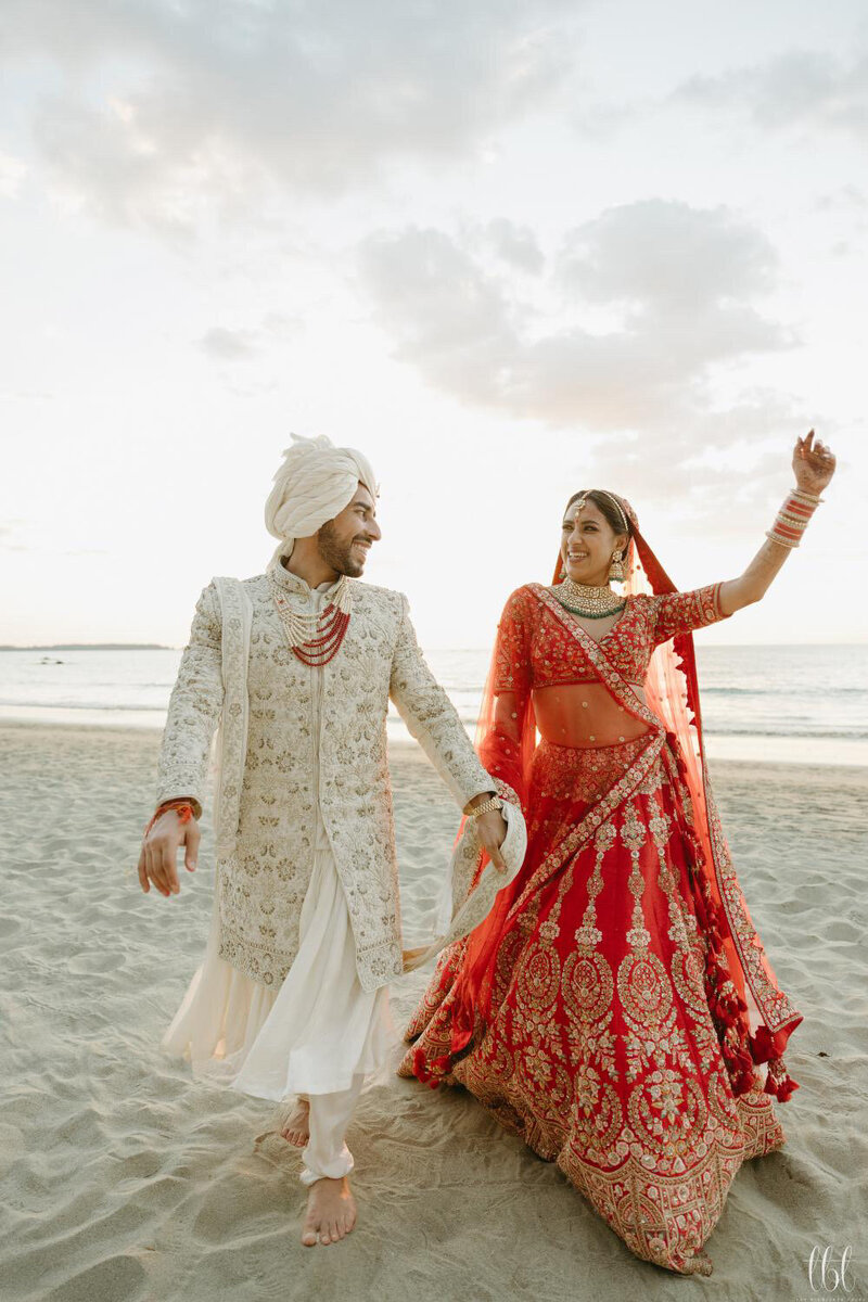 A Perfect Saree Draping  Bride and Groom enjoying a walk on the beach.