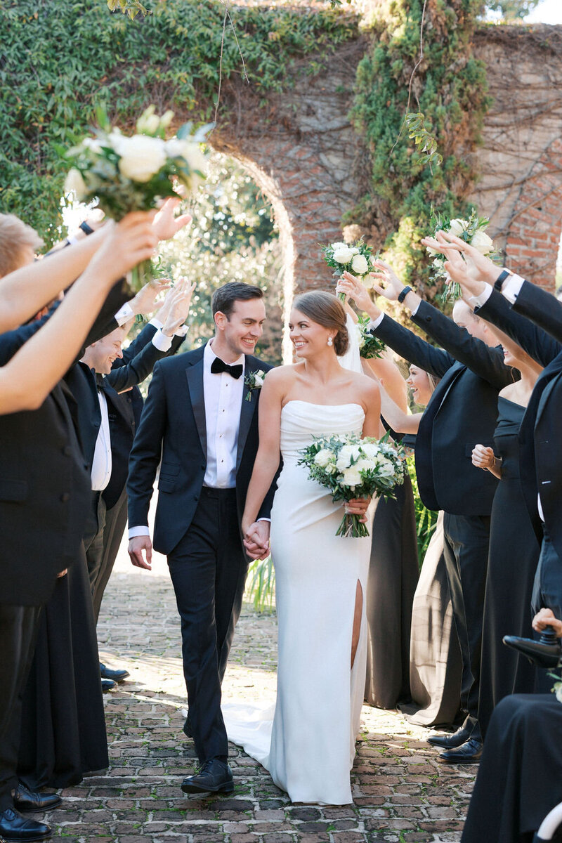 Bride and groom surrounded by wedding party at Summerour Studio