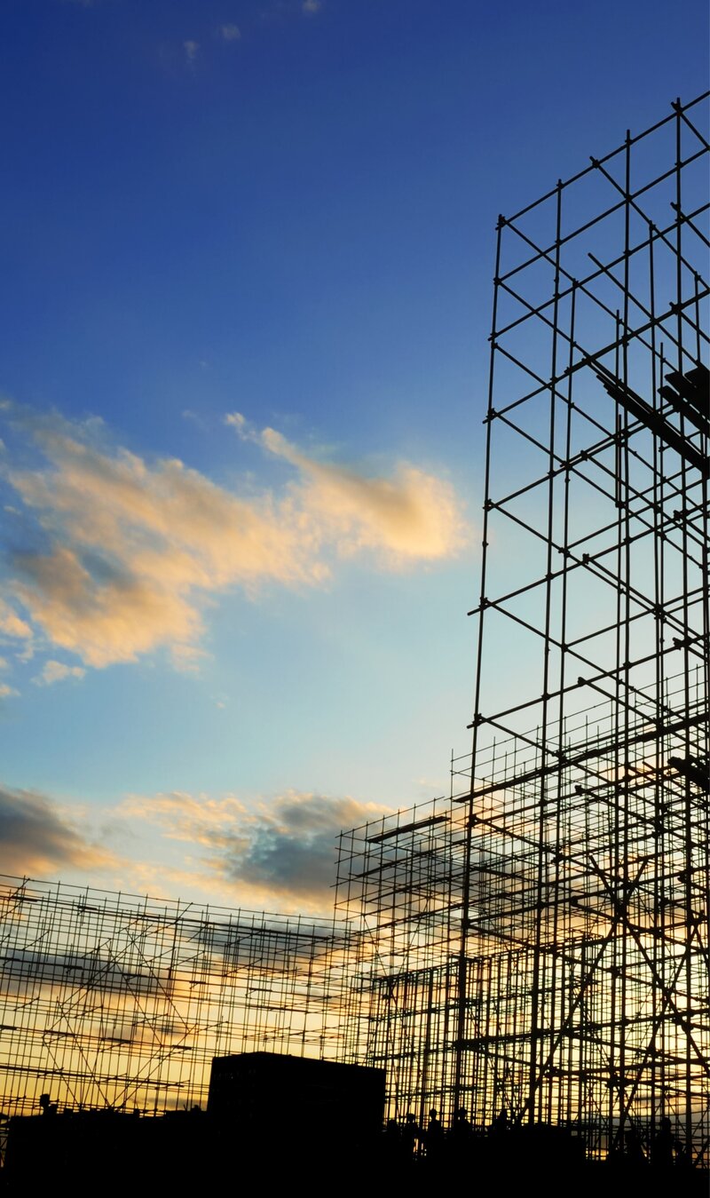 A construction site with scaffolding in the background.