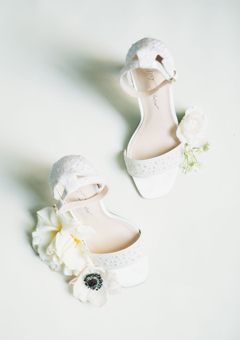 white wedding shoes with pearls. and flowers from a wedding in Washington D.C.