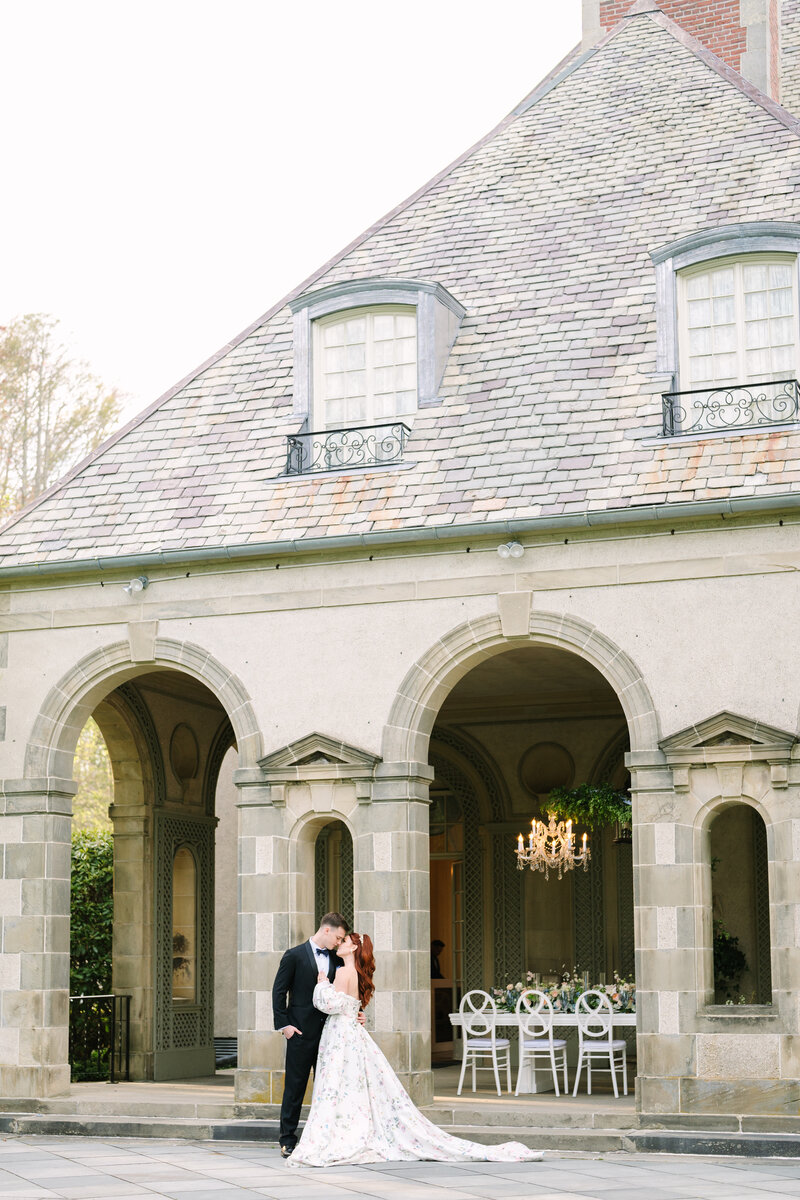 bride and groom smiling on the stairs during their pelham house resort cape cod wedding in