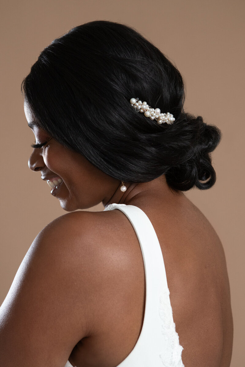 bride wearing a pearl comb in her updo