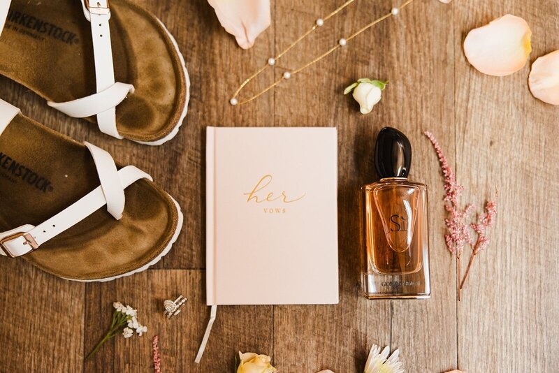 Vow book, perfume, sandals, and jewellery for the bride.