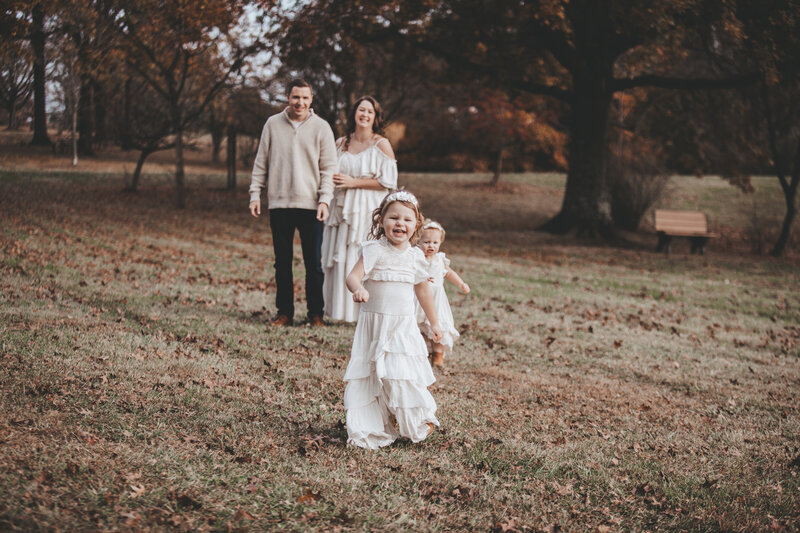 Family Portraits with toddler girls running toward camera