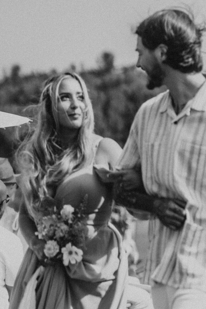 bridesmaid and groomsman walking down aisle together