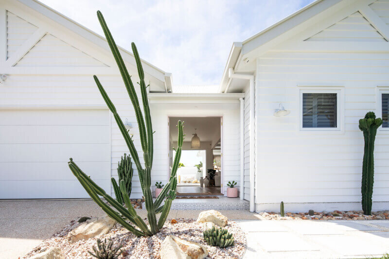 Front of house in Tweed Heads with white cladding and cactuses