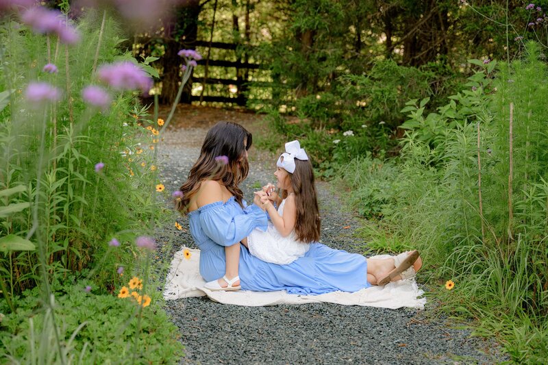 flower garden photo of a mother and daughter playing together