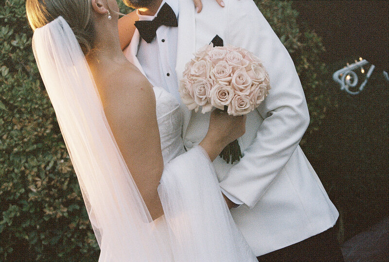 bride and groom holding hands walking into reception space