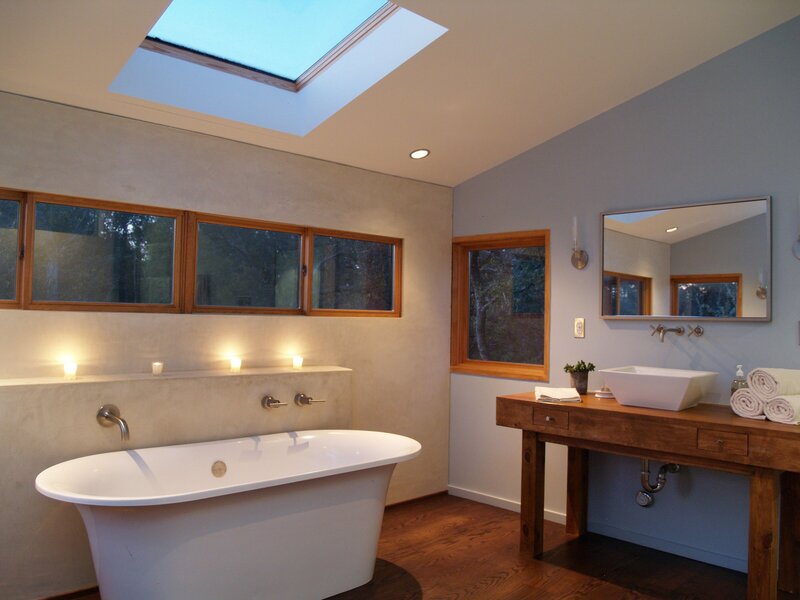 claw foot bathtub in luxury bathroom. wood countertop with glass sink