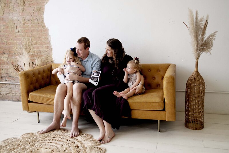 A family looks at the sonogram images as they reveal that a new baby is on the way.