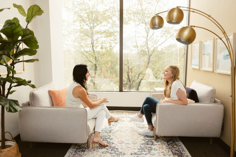 two women chatting in a therapy office