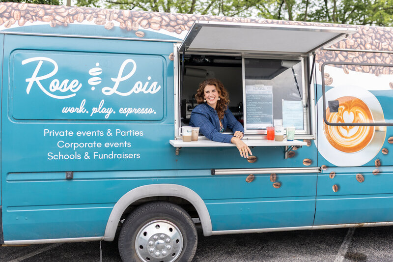 Rachel smiling while standing at the serving window of her coffee truck