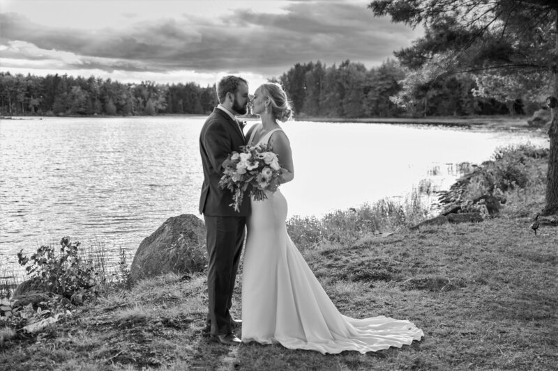 Bride and Groom kissing by the lake | Klein Wedding at Grace on the Lake taken by Wedding Photographer