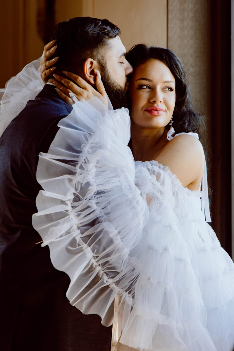 Man kissing women on the head