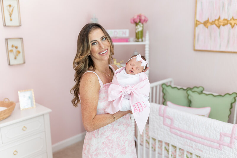 Mom holding baby in nursery