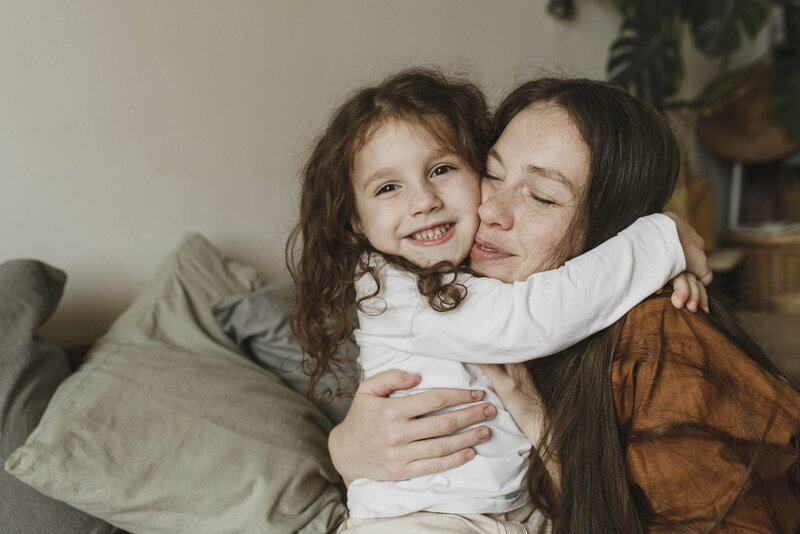Mom hugging daughter