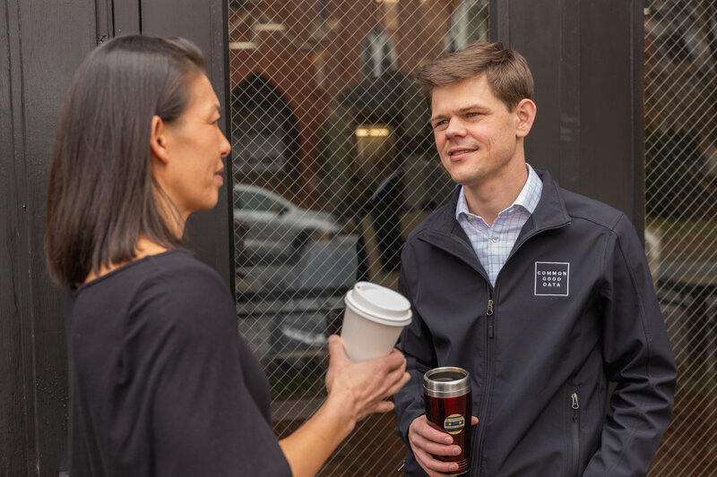 man an woman having a business conversation in front of a coffeeshop Atlanta GA during personal branding photo session