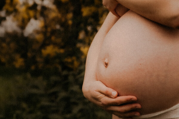 le ventre nu tenu par les mains de la future maman