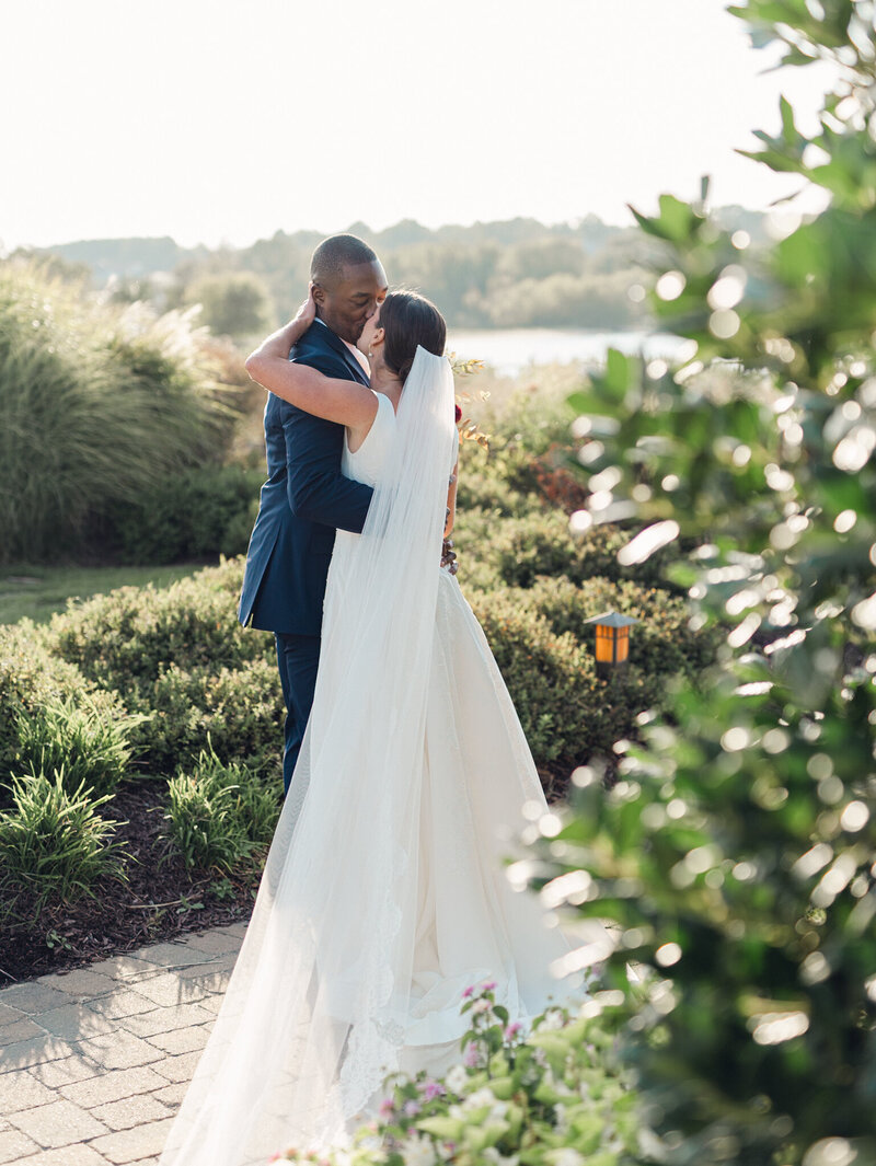 Bride and groom embracing and kissing, taken by one of the top wedding photographers in baltimore Nicole Simensky