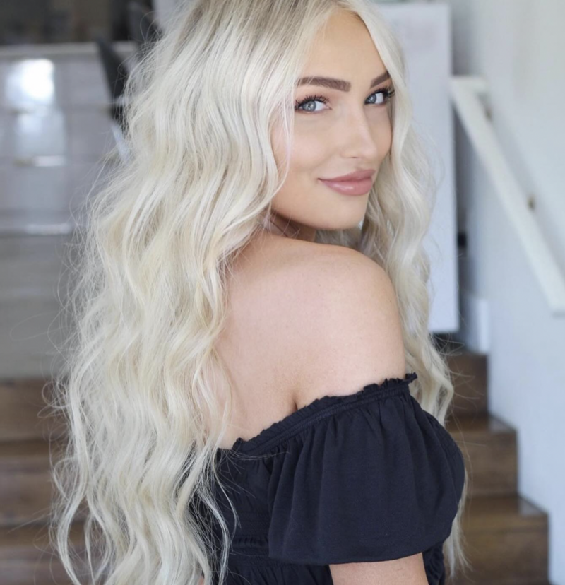 Blonde client in salon with new hair extensions