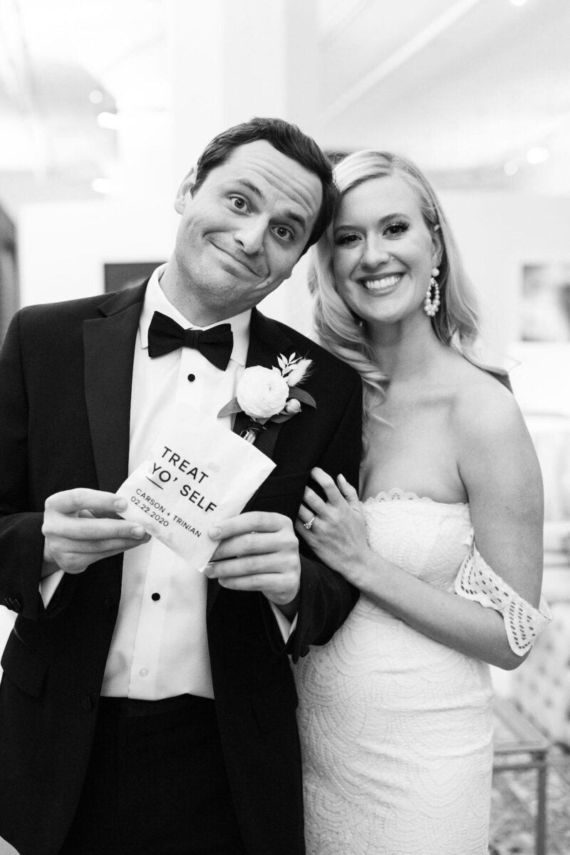 black and white photo of a bride and groom at their reception, smiling