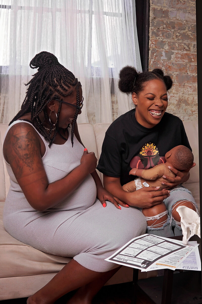 Doula offering education to an expecting mother.