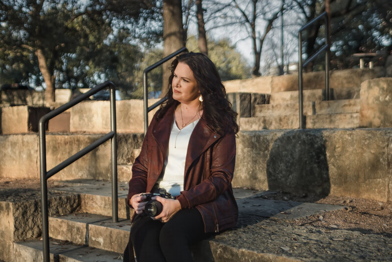 Jennifer in maroon jacket looking off-camera during branding session at The Pearl in San Antonio, TX.