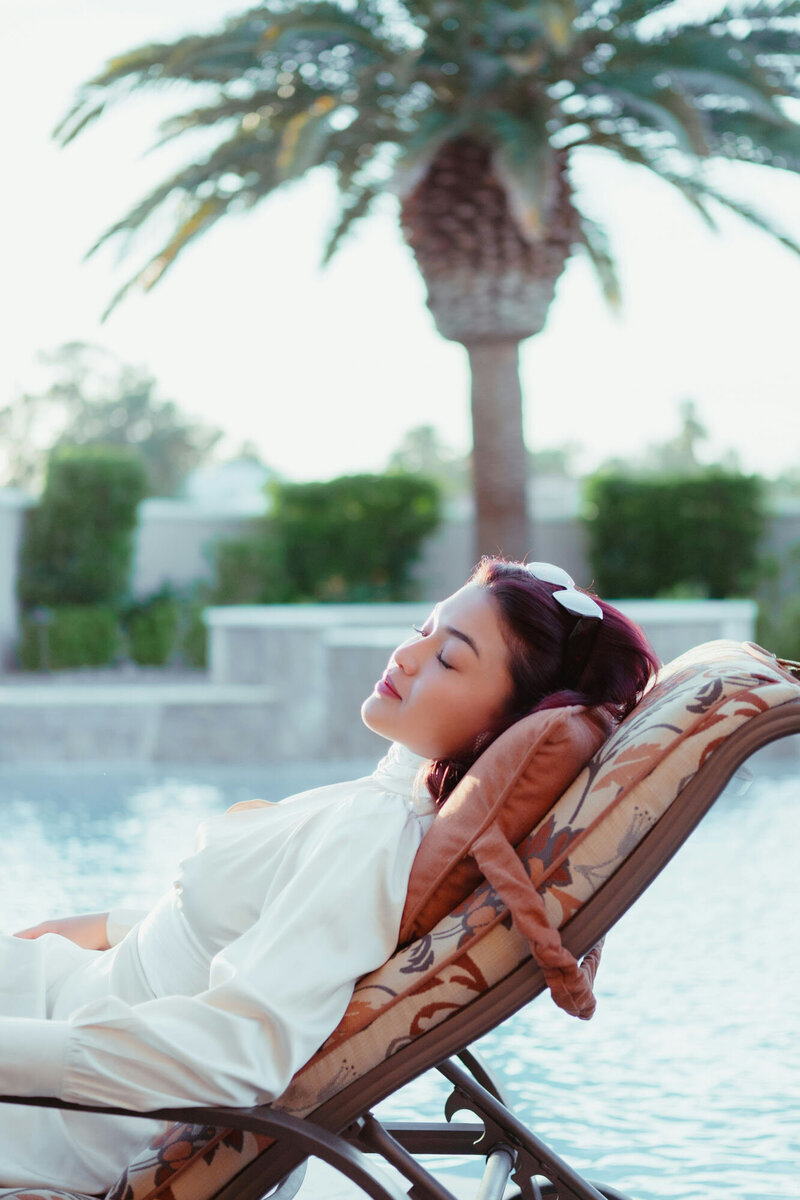 Woman laying in a chair with her eyes closed