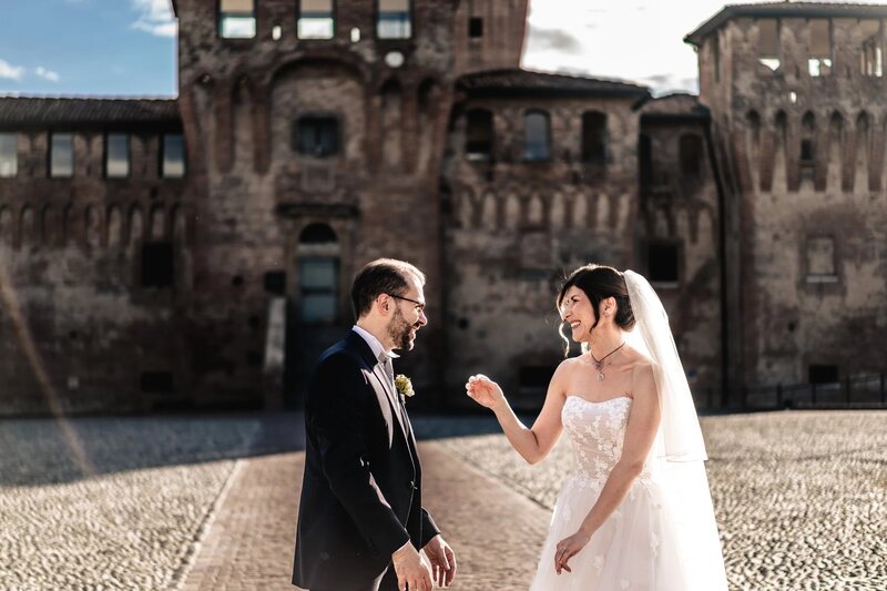 a bride and groom laughing together on their wedding day