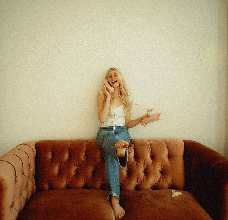 Young woman kicking out while holding a vintage phone in Pittsburgh Lifestyle Photo session