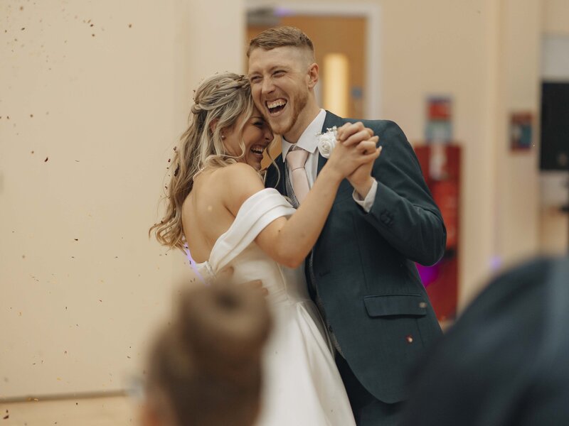 Bride and groom laughing during first dance