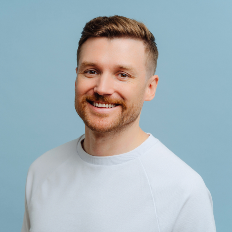 Healthy male smiling in white shirt on blue background