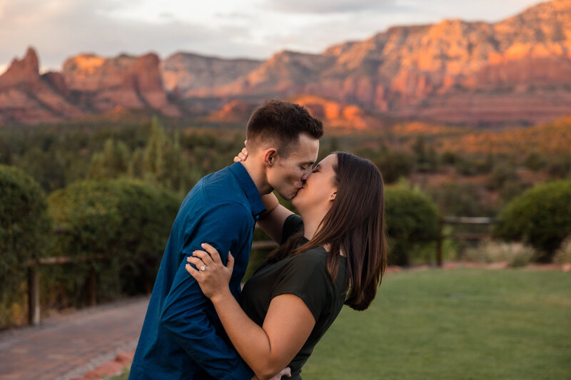 family smiling in front of superstition mountains