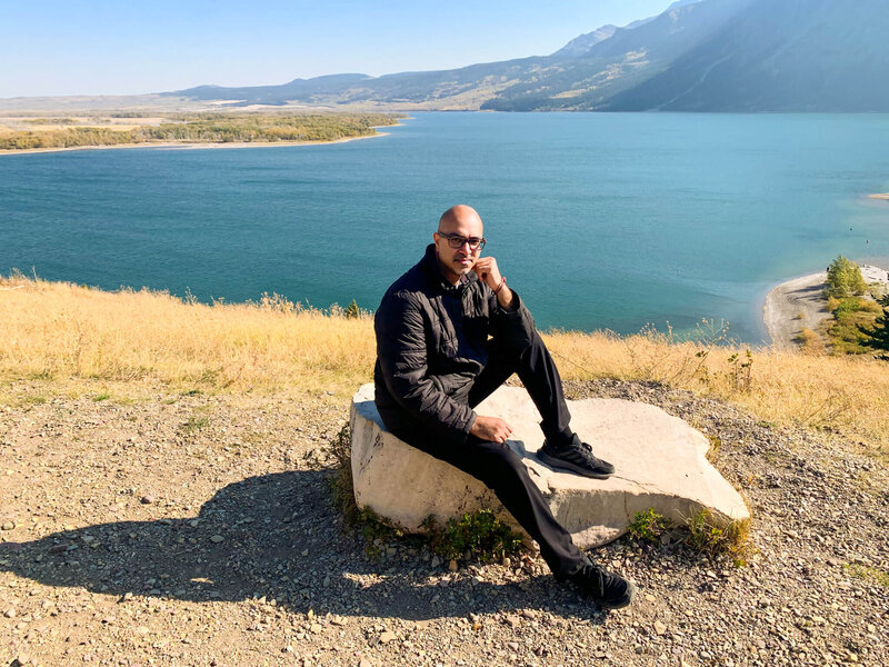 Arif Kassam Wedding Photographer posed on a rock by lake in Jasper