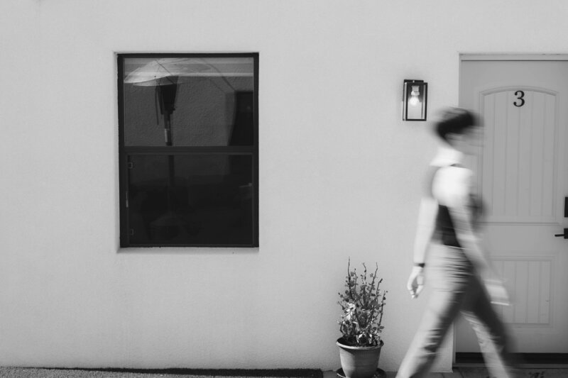 blurred woman walking in front of door