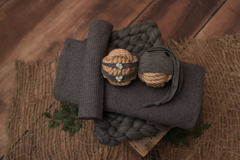 Charcoal gray backdrop set with matching wrap, hat and headband on crate