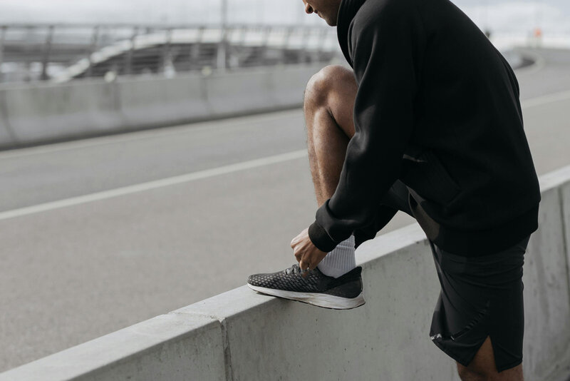 Personal trainer tying shoe