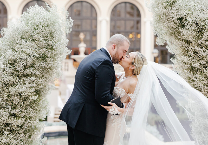 Couple walking in a hallway, photographed by Miami wedding photographer Claudia Amalia, illustrating her lifestyle and wedding photography skills.