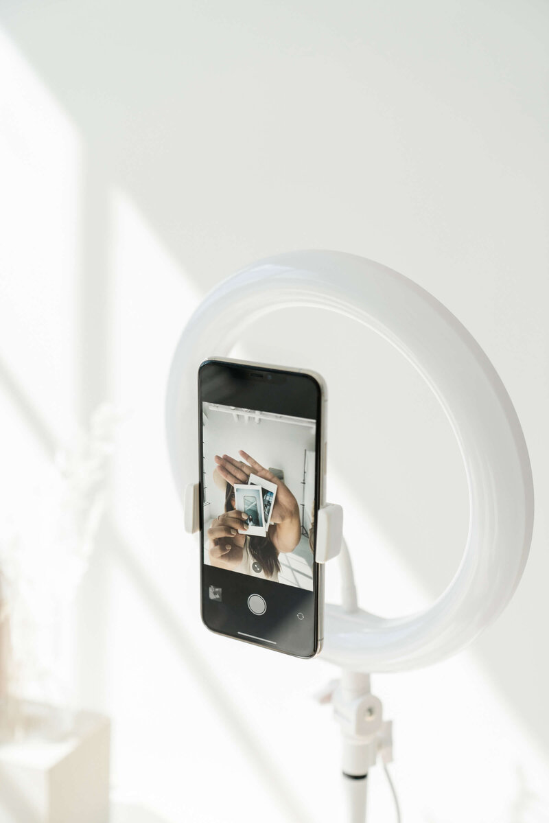 Light ring with a phone in it  with camera app open for social media images