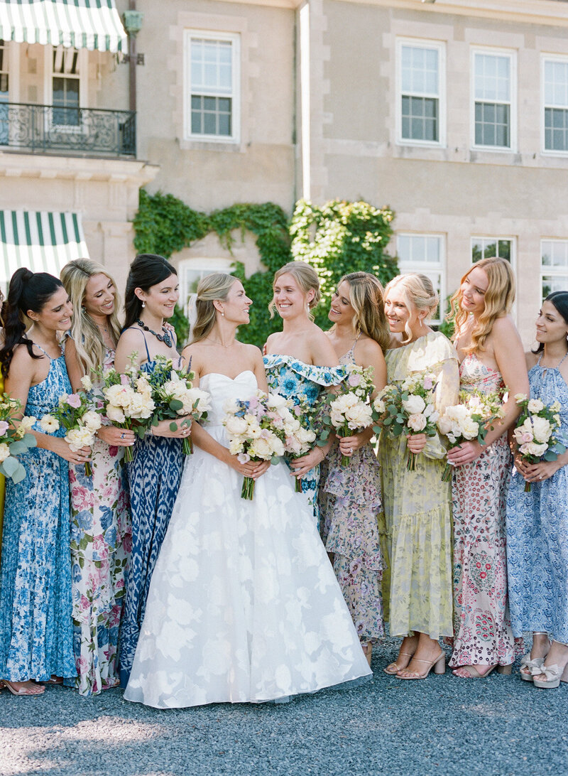 A bride with her bridesmaids in colorful dresses